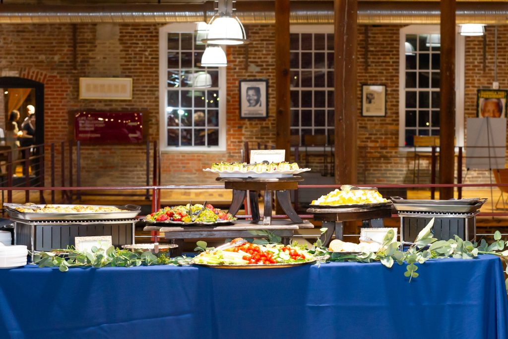 A beautiful appetizer display with vegetables, dips, and other tasty catering options.