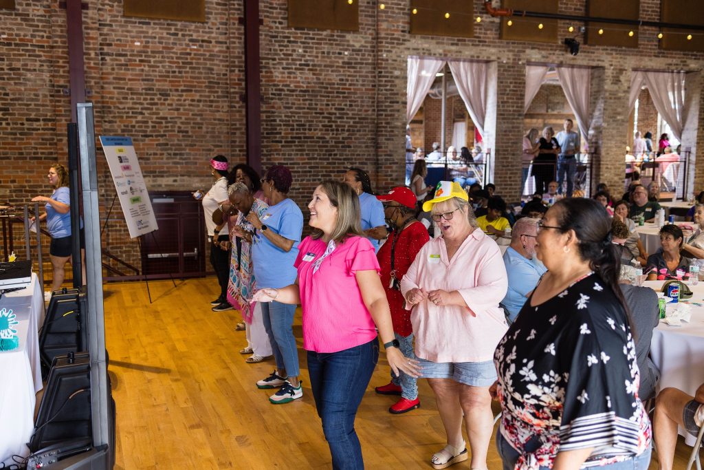 A group of women dance at Cancer Survivors Day event at the Power House.